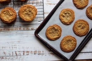 crispy chocolate chip cookies on baking tray and rack