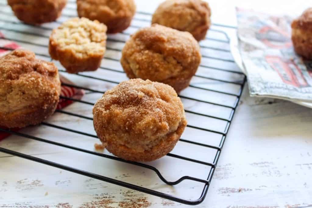cinnamon sugar donut muffins on wire rack with white background