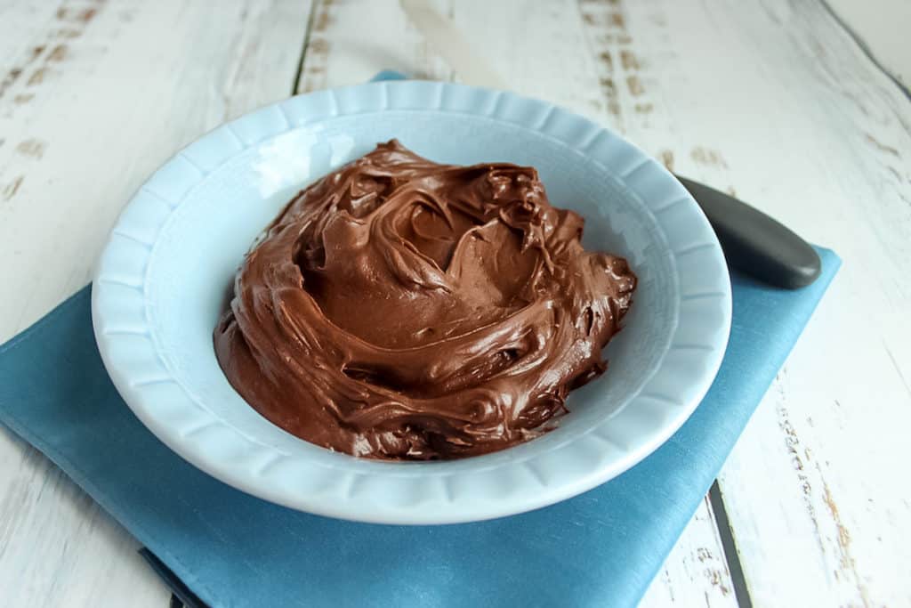 Chocolate sour cream frosting in blue bowl