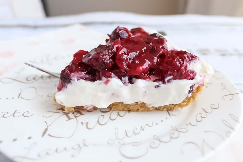 Slice of berry cheesecake on white plate