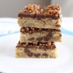 3 chocolate toffee bars stacked on a white plate