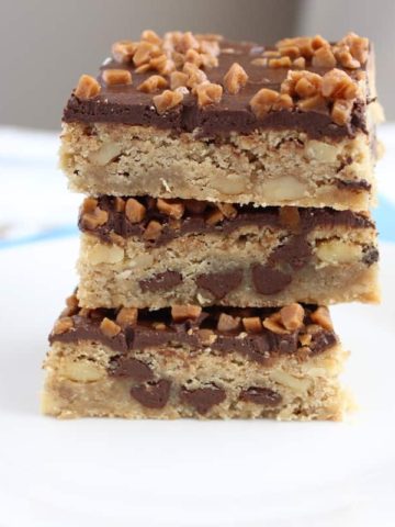 3 chocolate toffee bars stacked on a white plate
