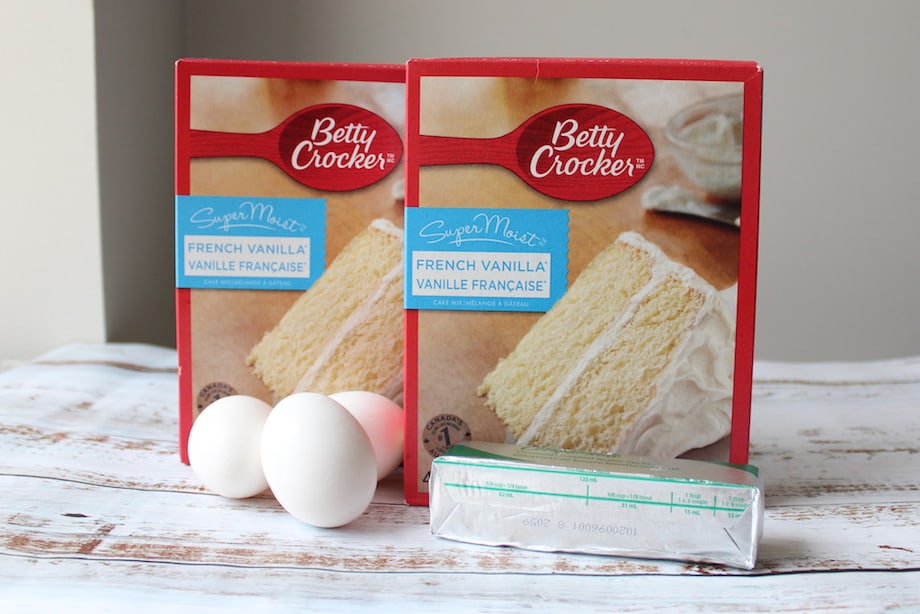 Two cake mix boxes with three eggs and one stick of butter