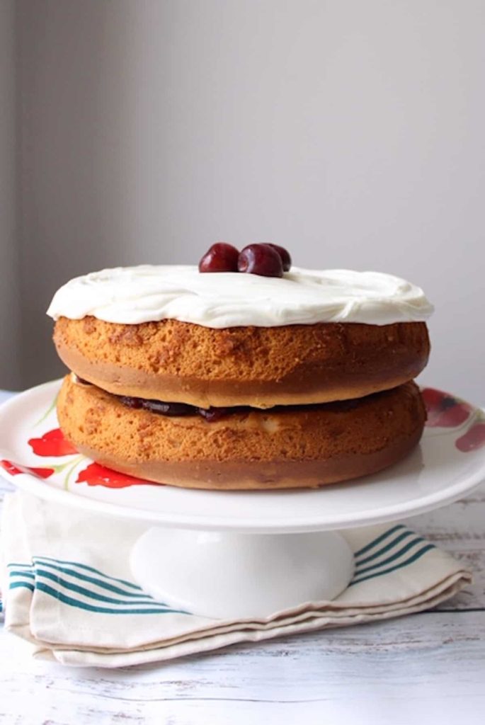 White Almond Sour Cream Cake on cake stand