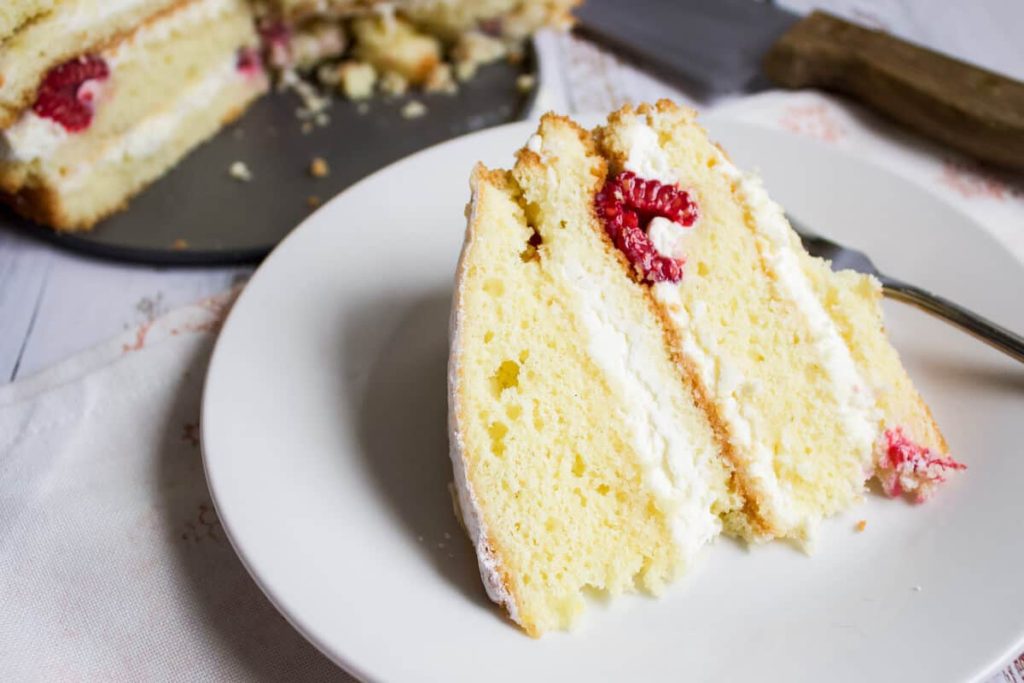 single slice or raspberry cake on white plate