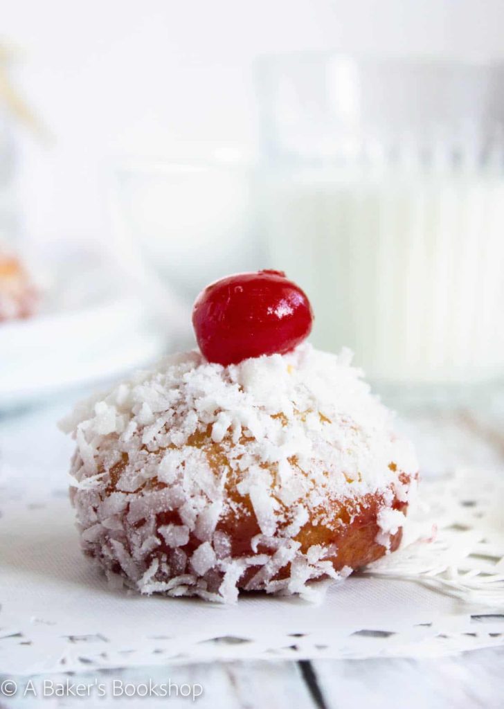 single jam and coconut cake on white doily