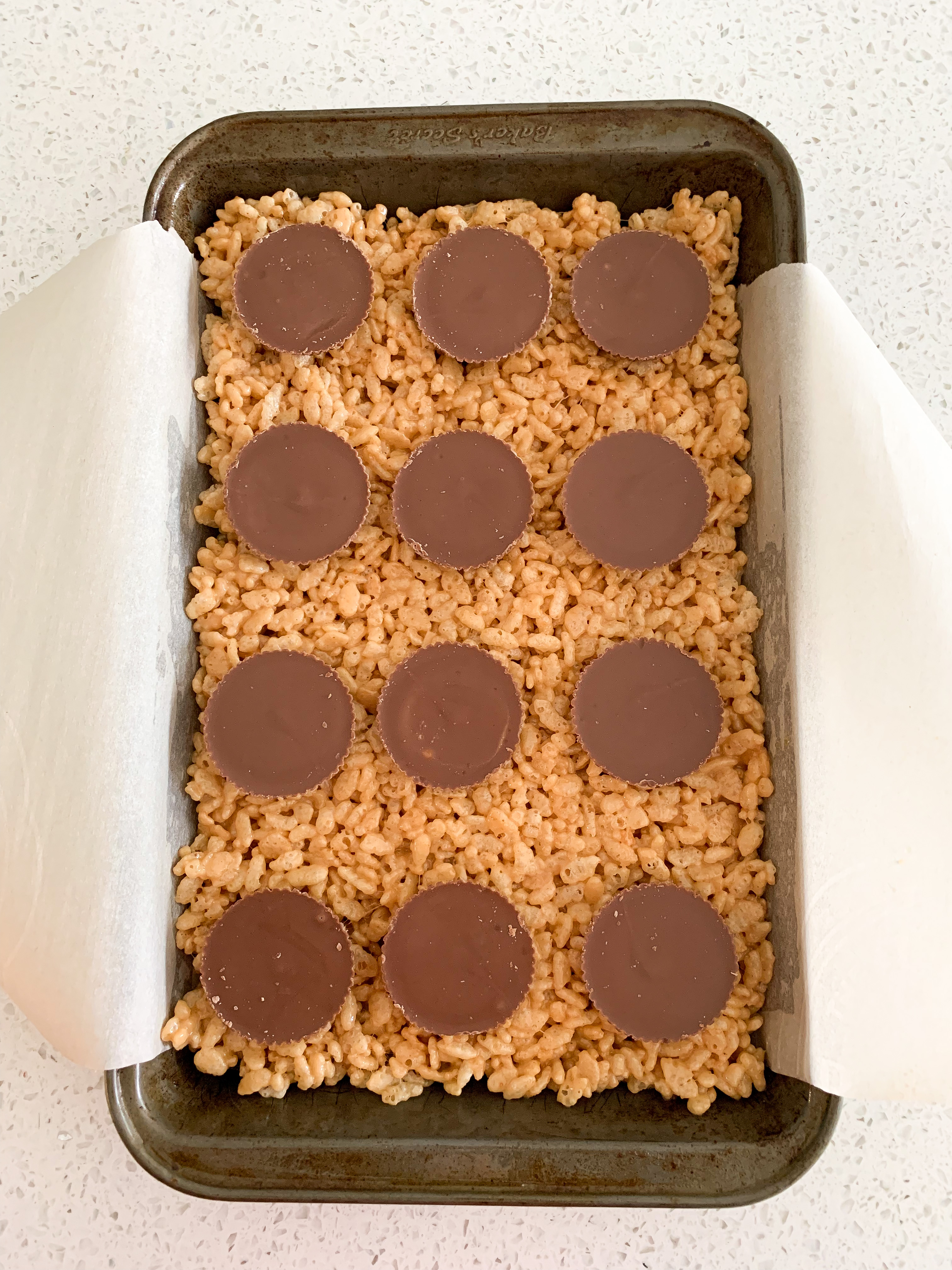 peanut butter cups on top of rice krispie squares