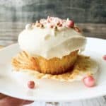 Almond cupcake with almond buttercream frosting on white plate