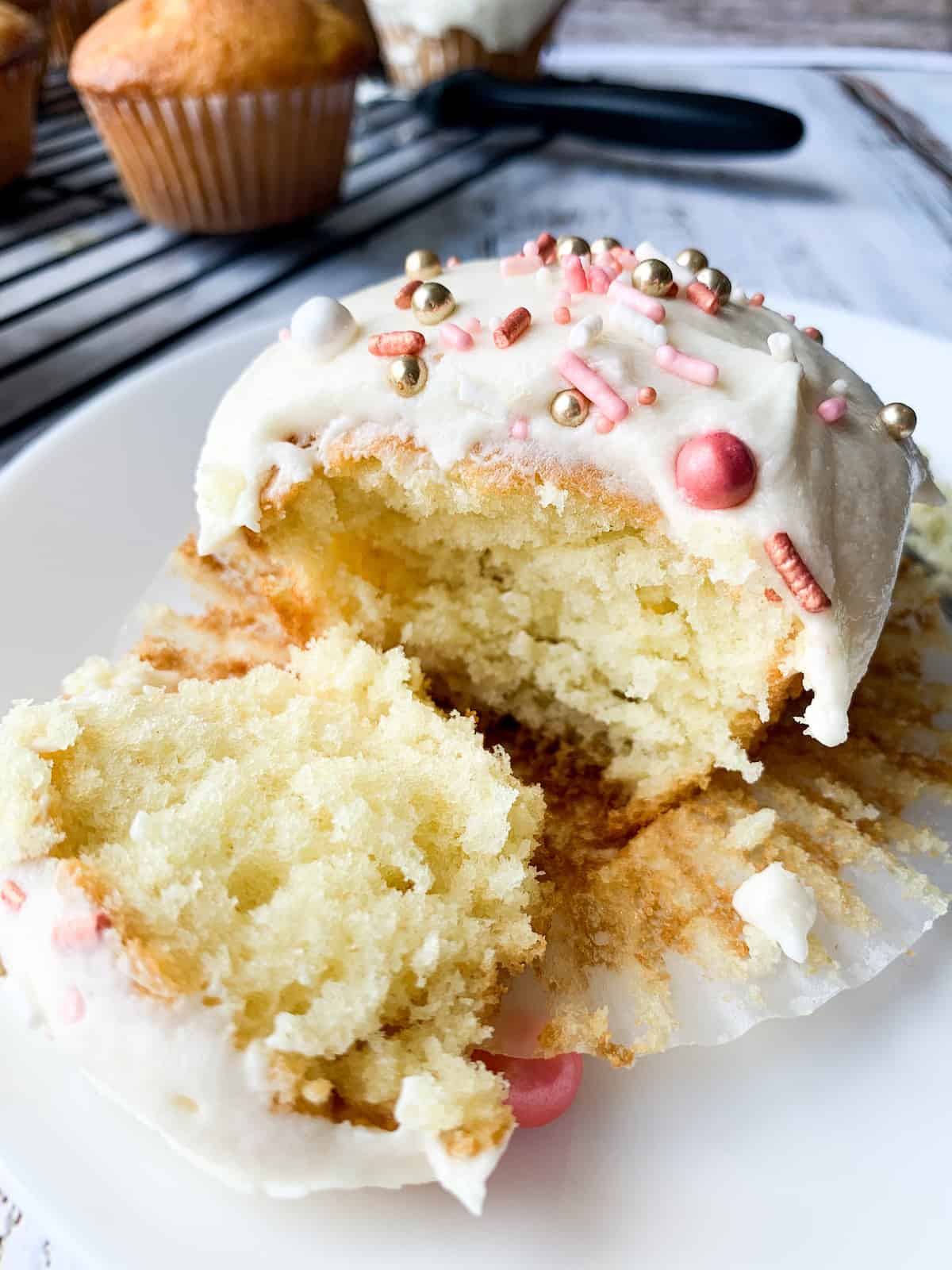 inside of almond cupcake with buttercream frosting