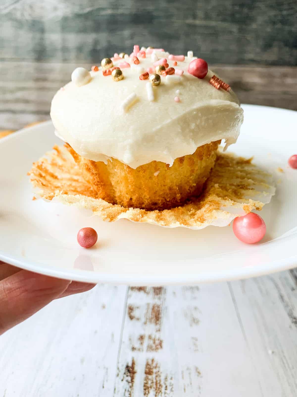 almond cupcake sitting on white plate