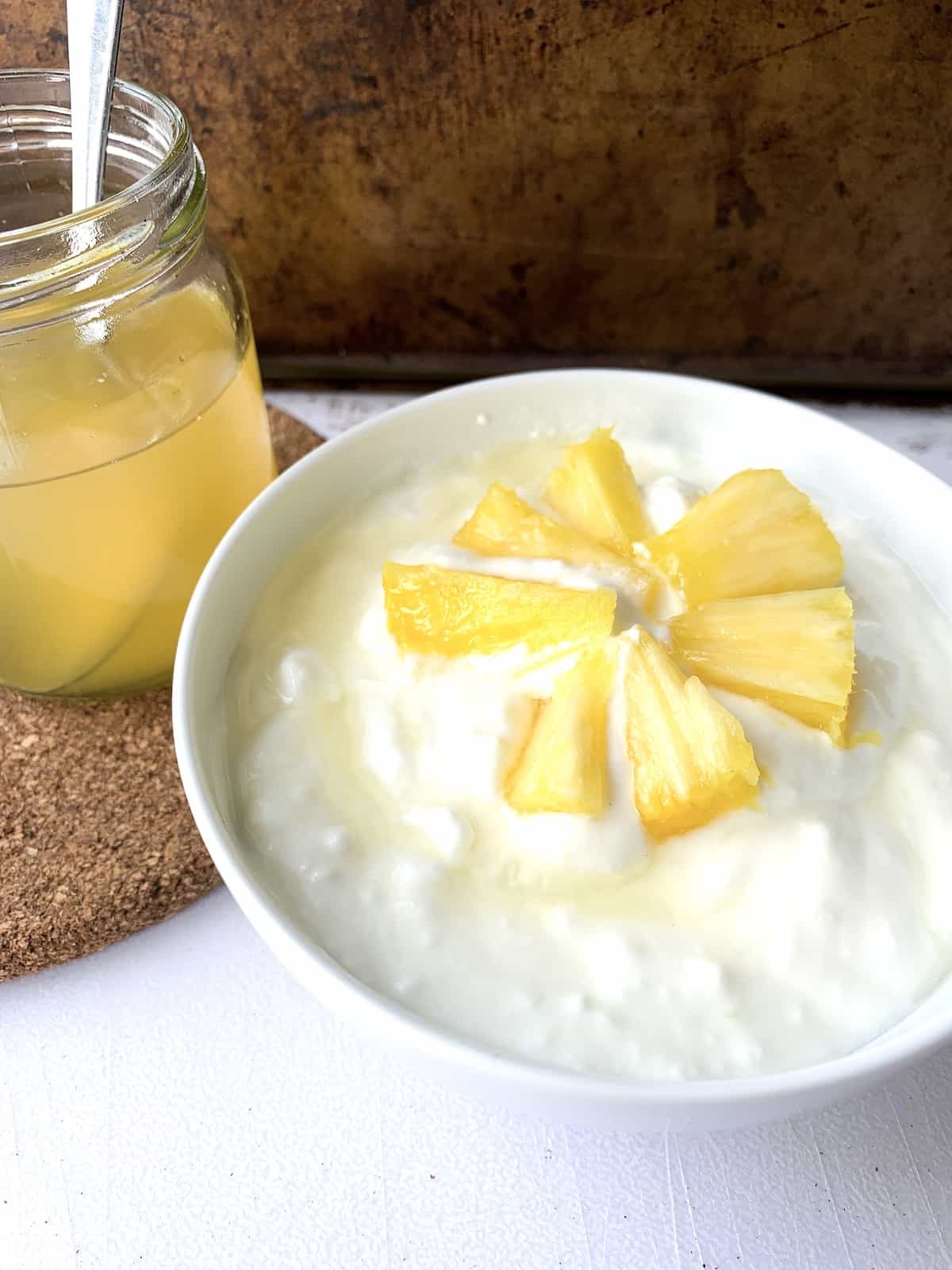 Yogurt with ginger pineapple syrup drizzled on top.
