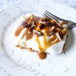 Labneh cheescake bar on white plate with dulce de leche topping