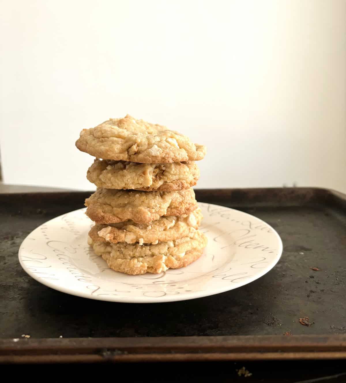 Stack of lemon meringue pie cookies on a white plate.