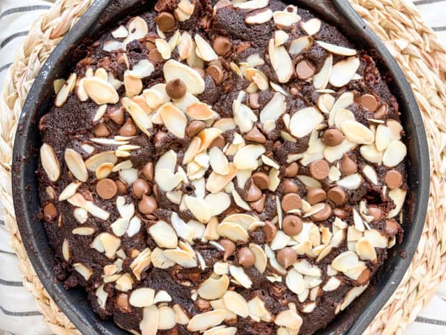 chocolate cake topped with chocolate chips and sliced almonds