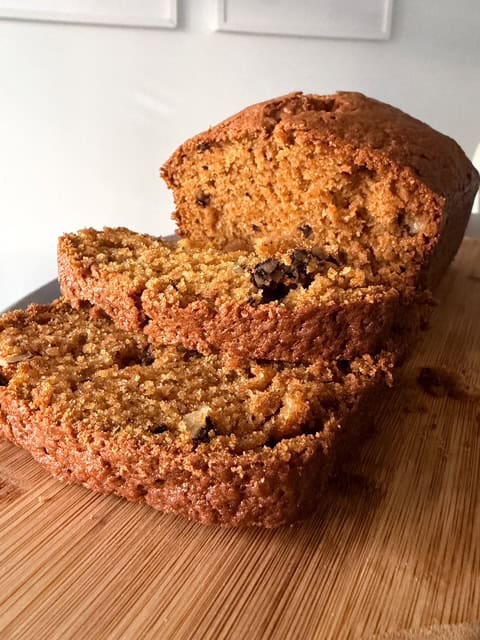 pumpkin bread slices on a wooden cutting board