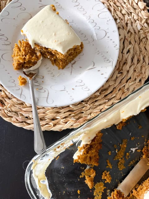 Serving up some pumpkin spice cake on white plate.
