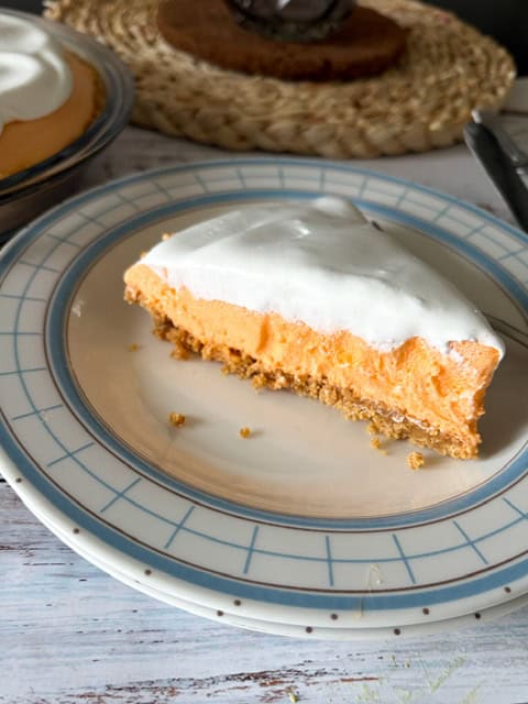 slice of orange pie on a white plate
