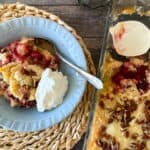 bowl of dump cake beside the larger cake pan