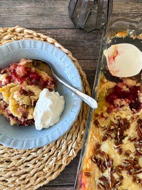 bowl of dump cake beside the larger cake pan