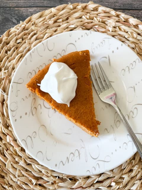 slice of pumpkin pie on a white plate